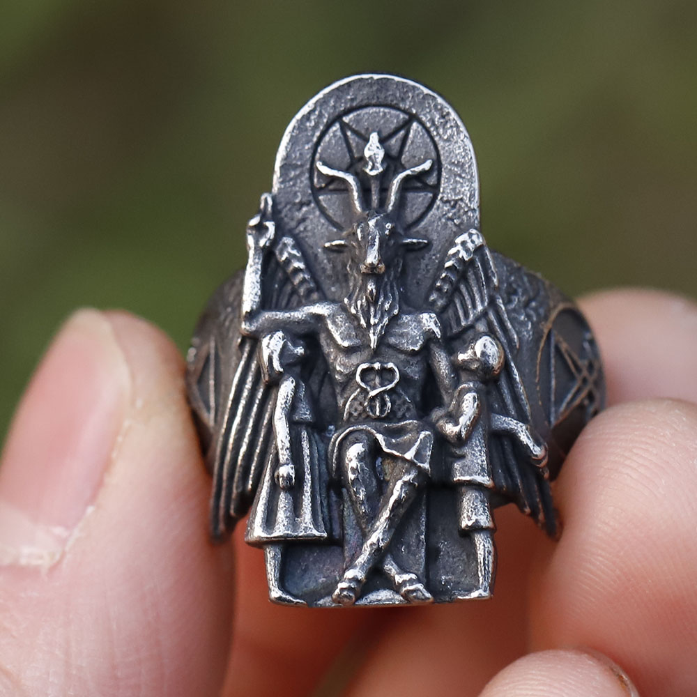 Close-up of the Baphomet figure on the signet ring, showing horns and pentagram detail.