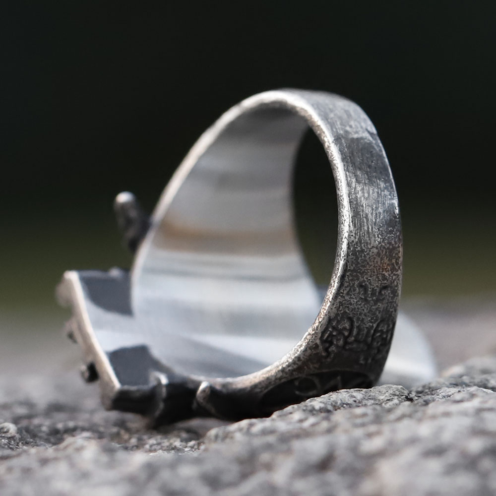 Overhead close-up of the Baphomet signet ring, emphasizing texture and design.