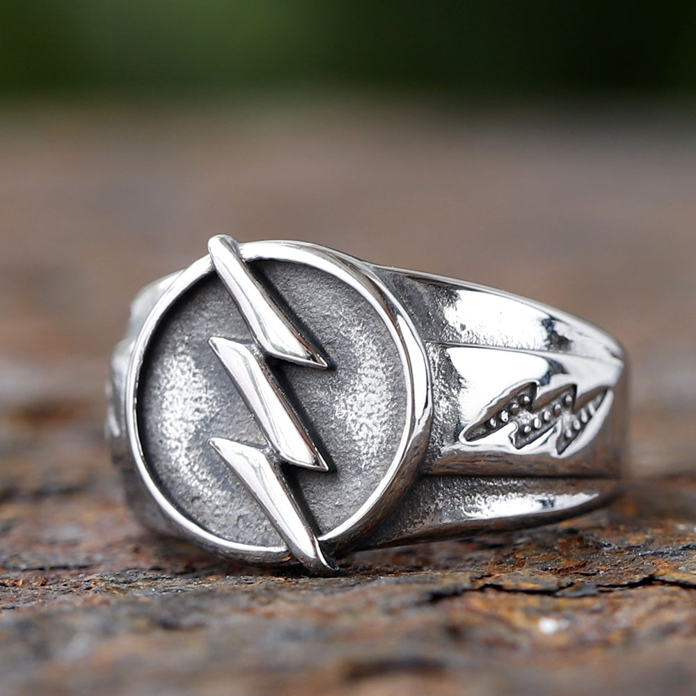 Close-up of the golden lightning bolt detail on the men's steel ring face