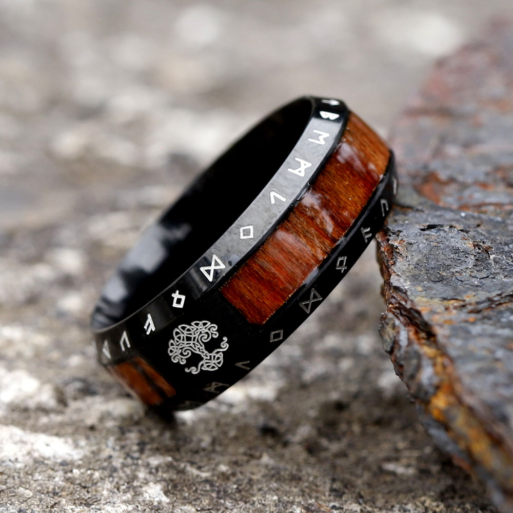 Angled shot showing the Futhark runes etched into the stainless steel band of the Viking ring.