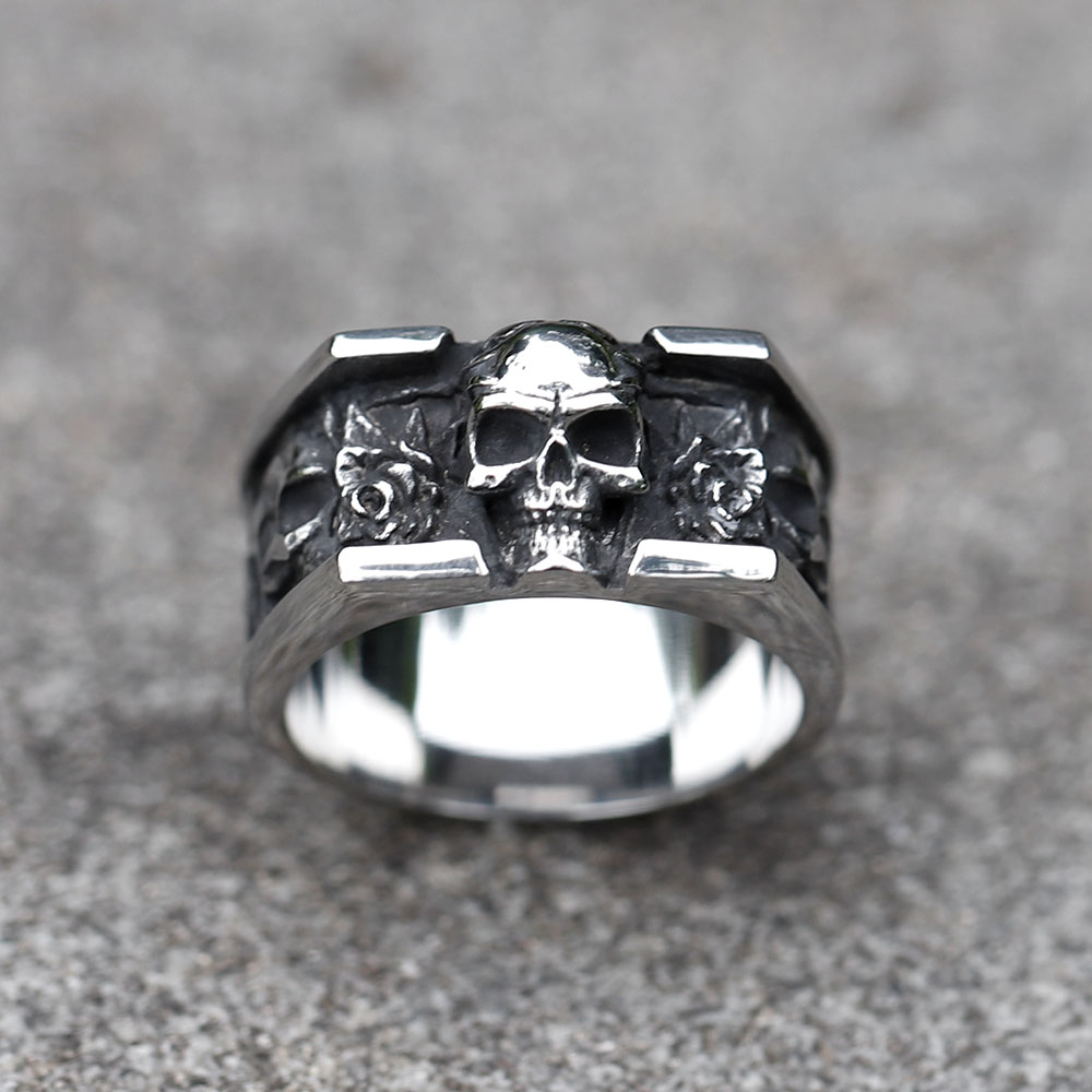 Close-up of the vintage skull design on the men's stainless steel ring, highlighting the detailed forehead and upper jaw from a top-left angle.