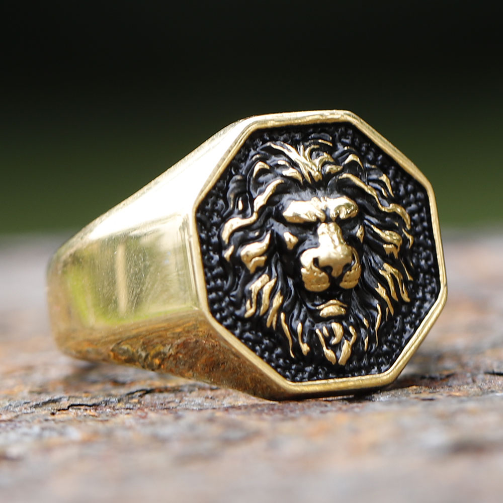 Close-up of the intricate lion's face on the stainless steel ring, highlighting its bold texture.