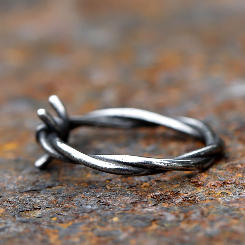 Front view of the unique twisted design of the stainless steel barbed wire ring.