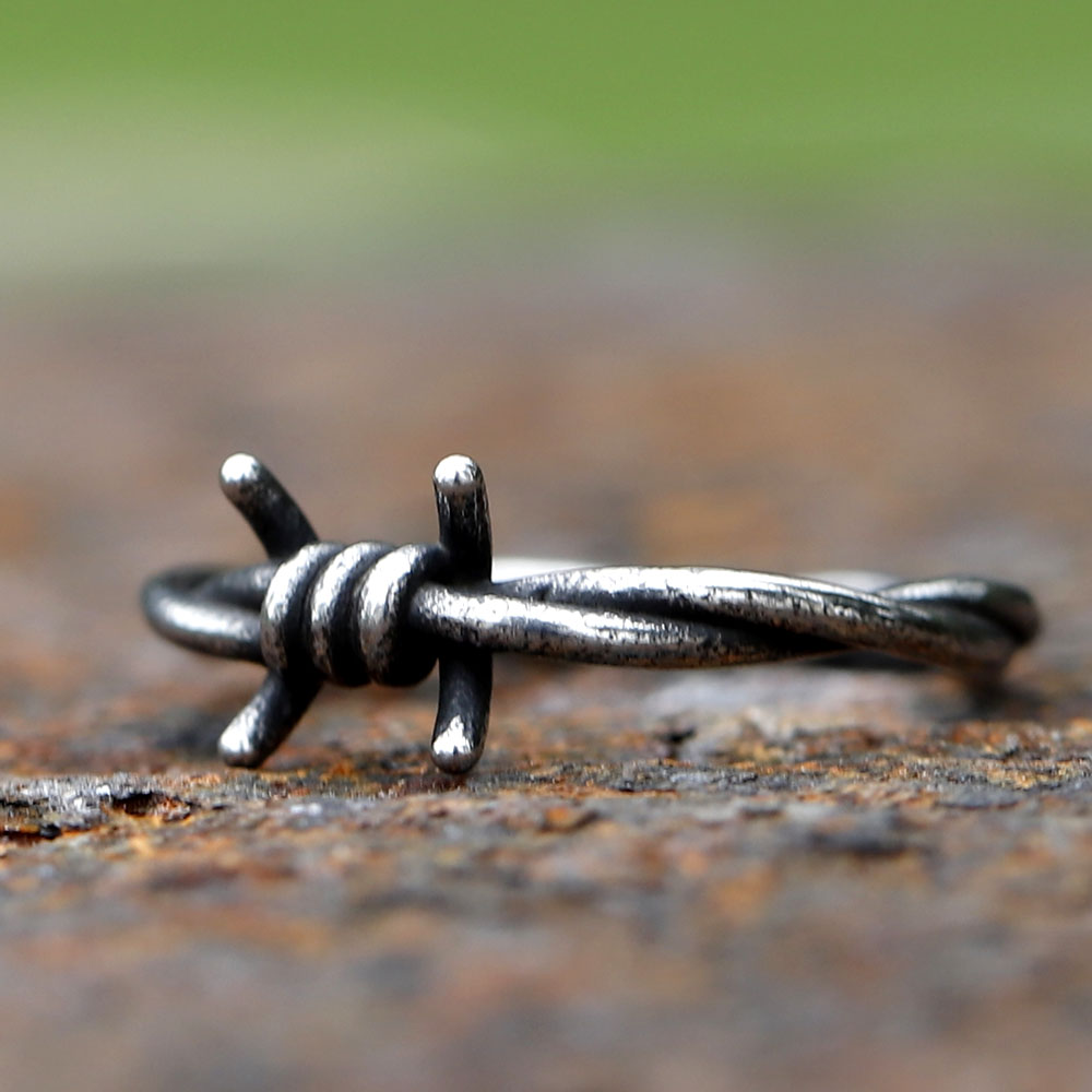 Detailed shot of the oxidized finish on a punk biker style barbed wire ring.