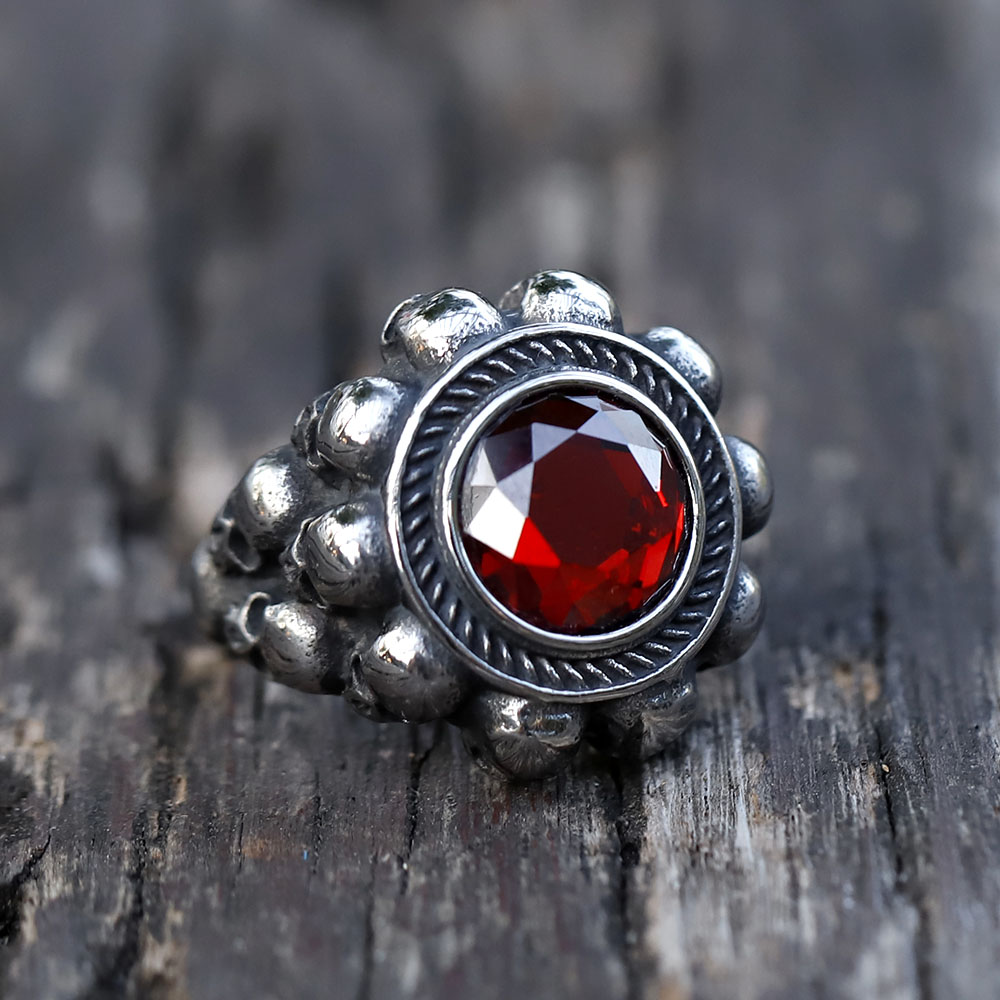 Close-up of the top portion of the gothic skull ring, highlighting the red zircon and surrounding details.