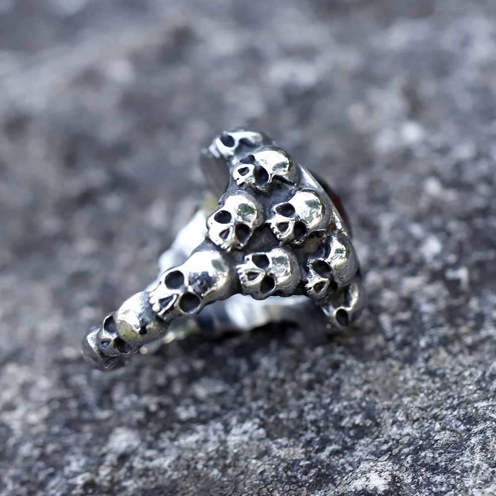 Detailed view of the red zircon gemstone and its intricate bezel setting on the skull ring.