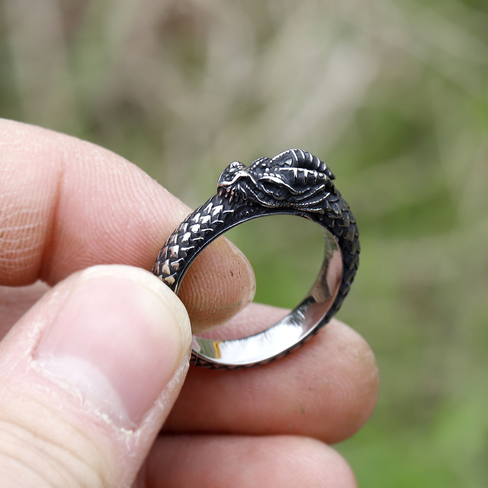 Detailed view of the smooth inner band and textured exterior of the dragon ring.