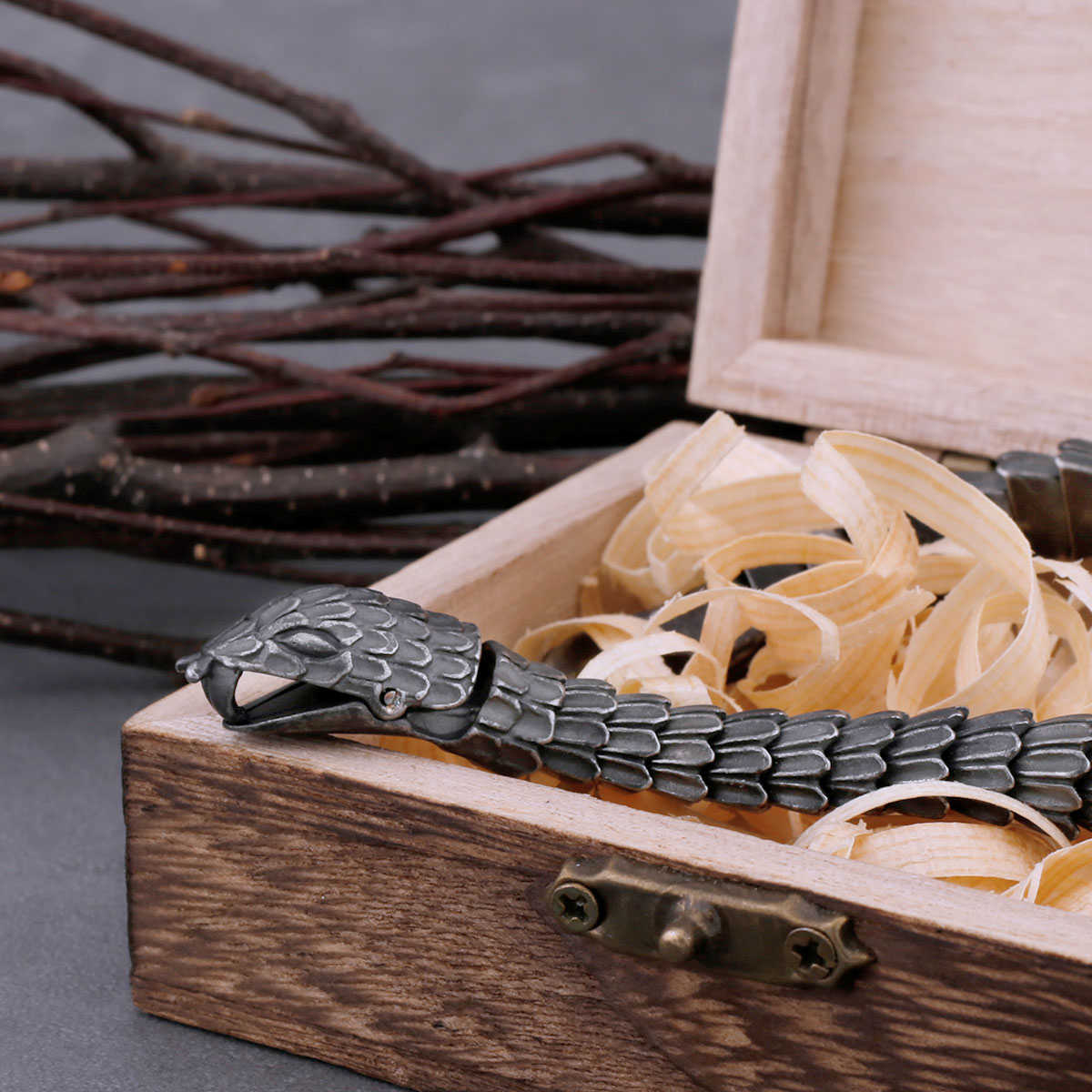 Macro shot of the intricately detailed snake head clasp and the unique scale texture of the Viking-inspired bracelet.