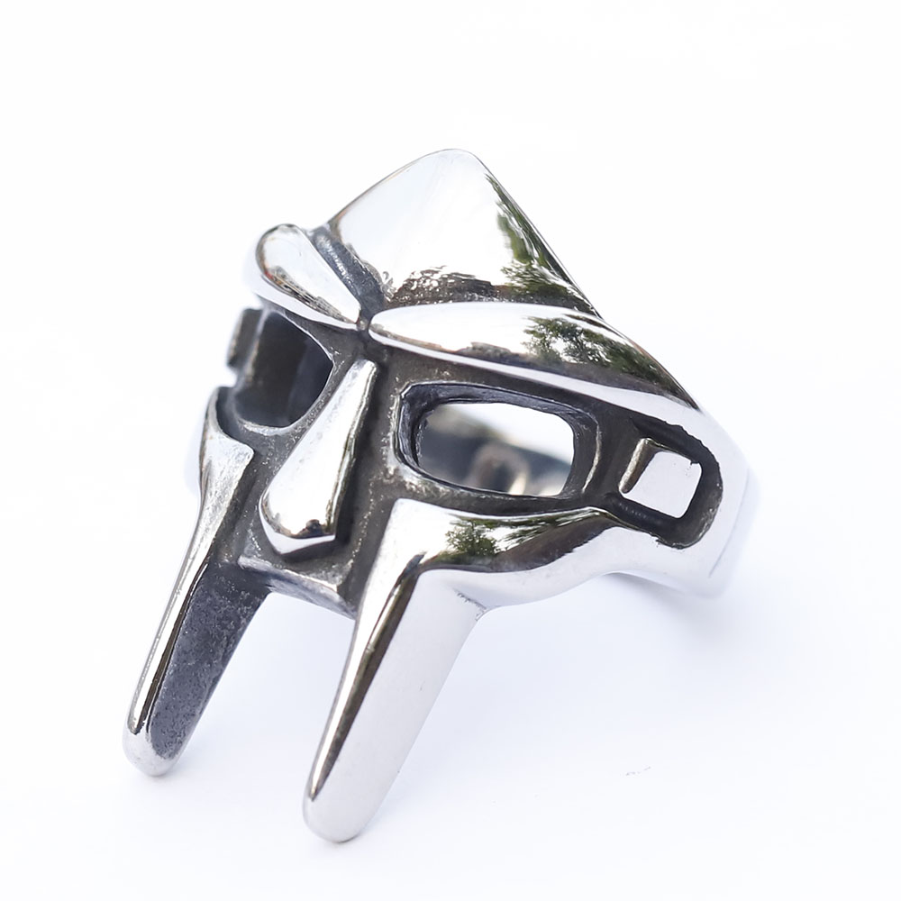 Dynamic shot of the stainless steel MF Doom ring, capturing its hip hop and punk aesthetic.