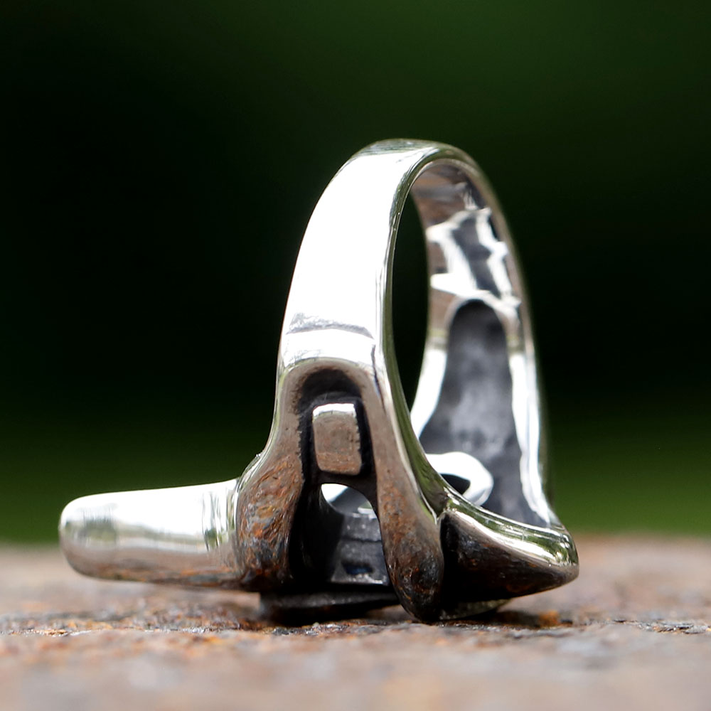 Angled view of the unique men's stainless steel ring, showcasing the iconic mask motif.