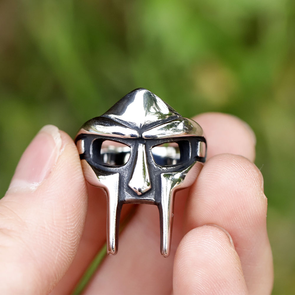 MF Doom mask ring displayed from above, emphasizing its solid construction and metallic sheen.