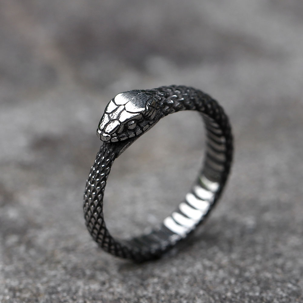 Close-up of the detailed snake head design on the stainless steel ring.