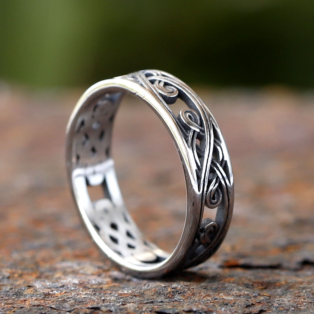 Side angle showing the texture and depth of the Celtic knot motif on the ring's band