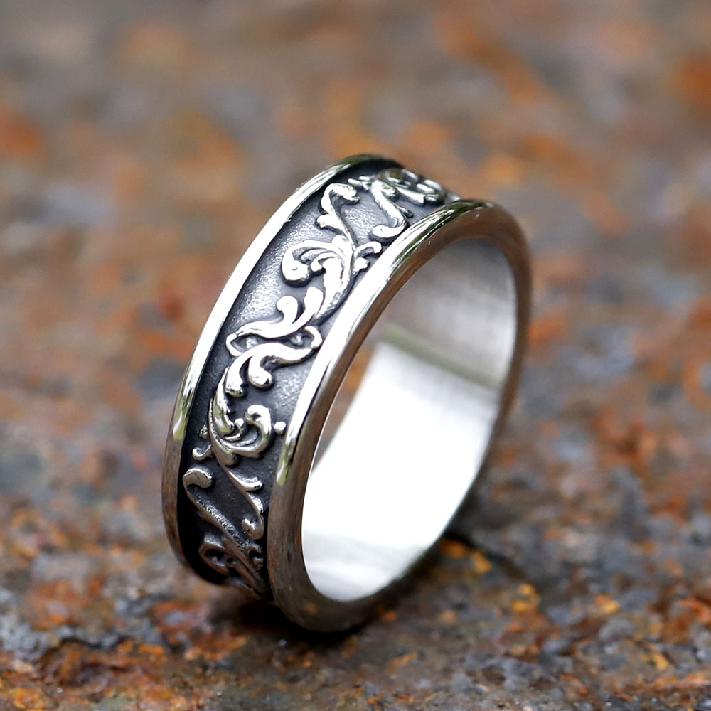 Close-up of a stainless steel ring featuring an intricate oxidized vintage Viking spindrift pattern.