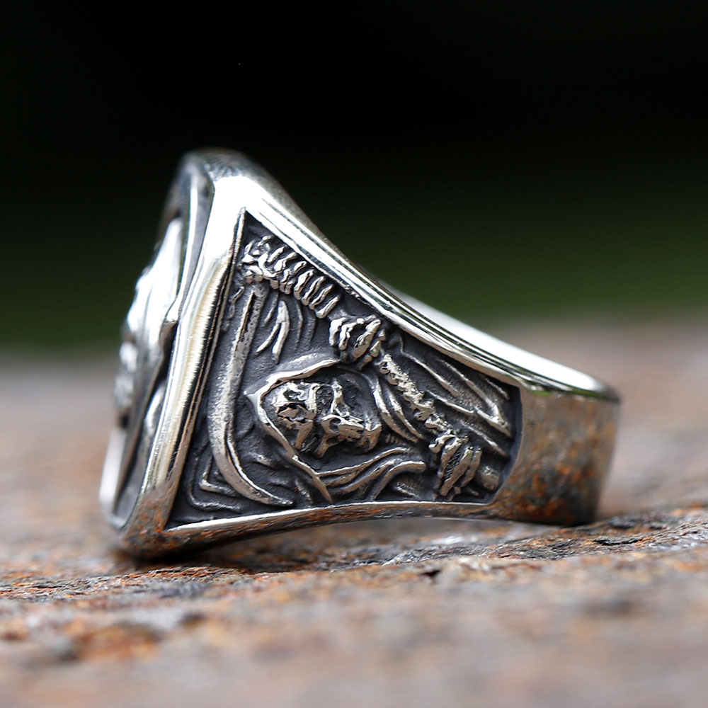 Close-up of the death sickle and patterned background on the right side of the stainless steel ring.