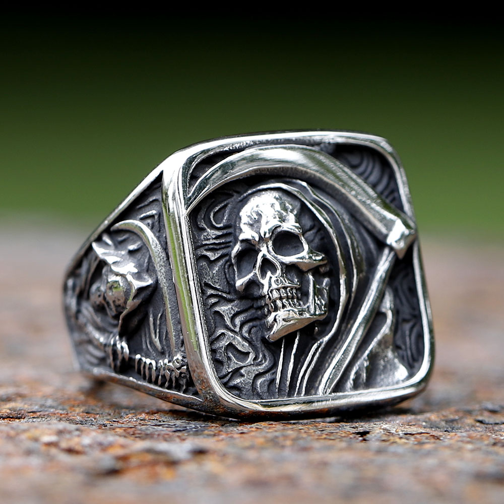 Front-angle close-up highlighting the intricate skull and cowl design on the men's stainless steel ring.