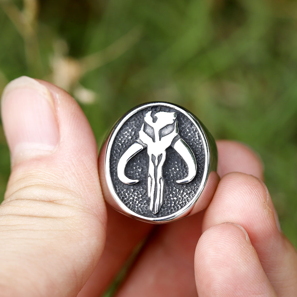 Stainless steel signet ring featuring the Mythosaur skull, shown from a slightly elevated perspective.