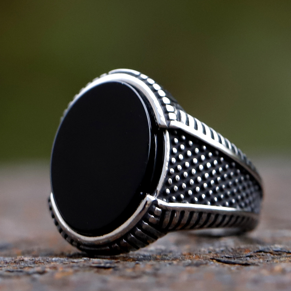 Detailed view of the textured silver-toned band of the totem ring
