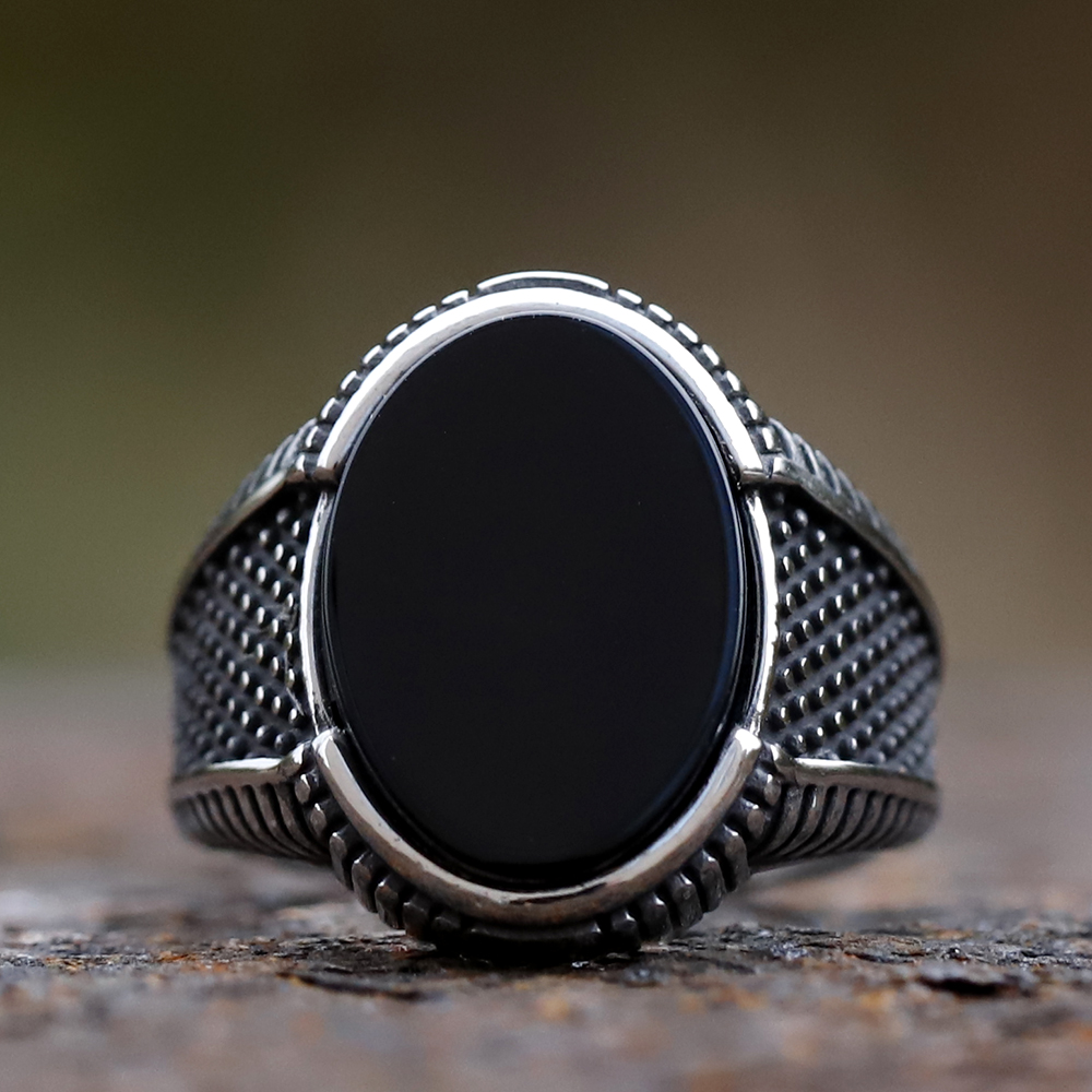 Close-up of the polished black zircon stone on a vintage men's ring