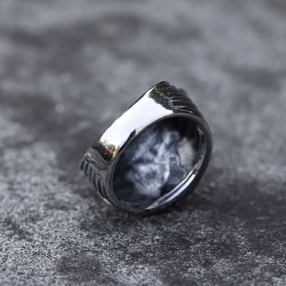 Detailed view of the ribbed band and skull moth feature of the men's stainless steel ring.