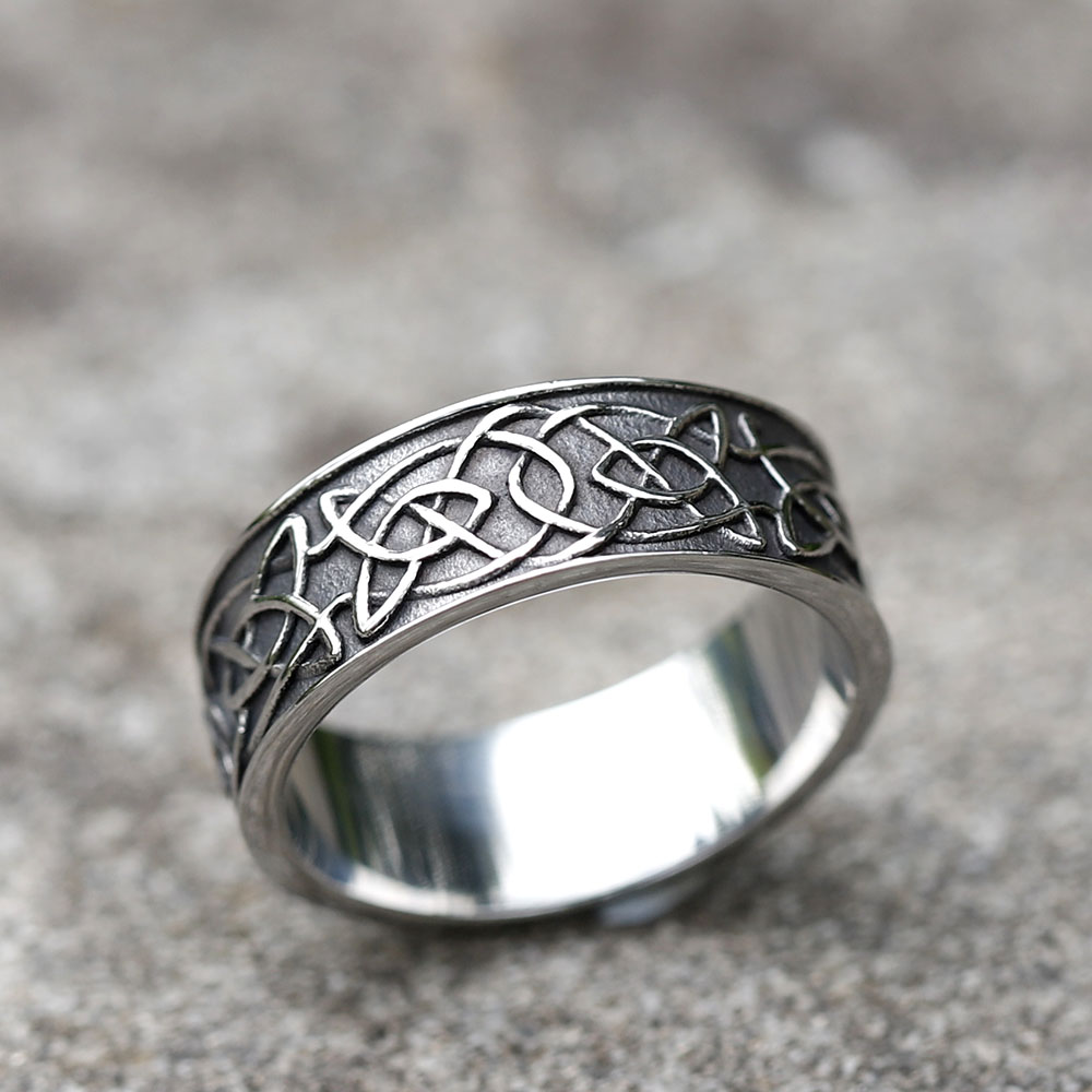 Angled shot of the 316L stainless steel ring, highlighting the detailed carved animal motif and brushed finish