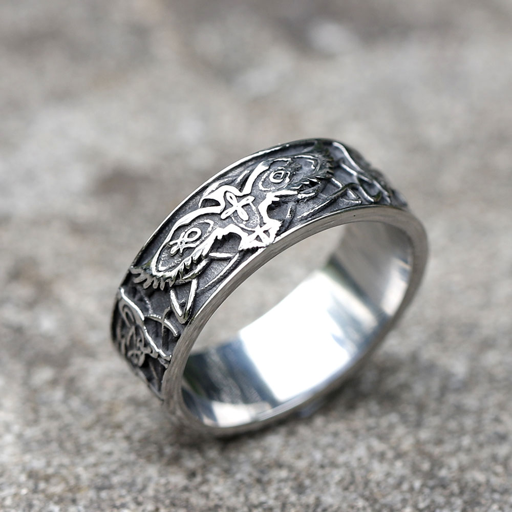Close-up of the Men's 316L stainless steel Viking eagle ring on a textured grey surface
