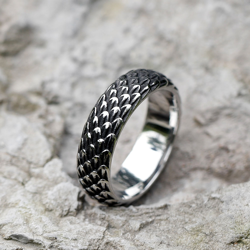 Men's 316L stainless steel Viking dragon scale ring on a textured grey surface.