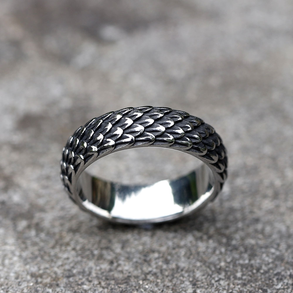 Detail view of the intricate dragon scale pattern on the vintage Nordic ring.
