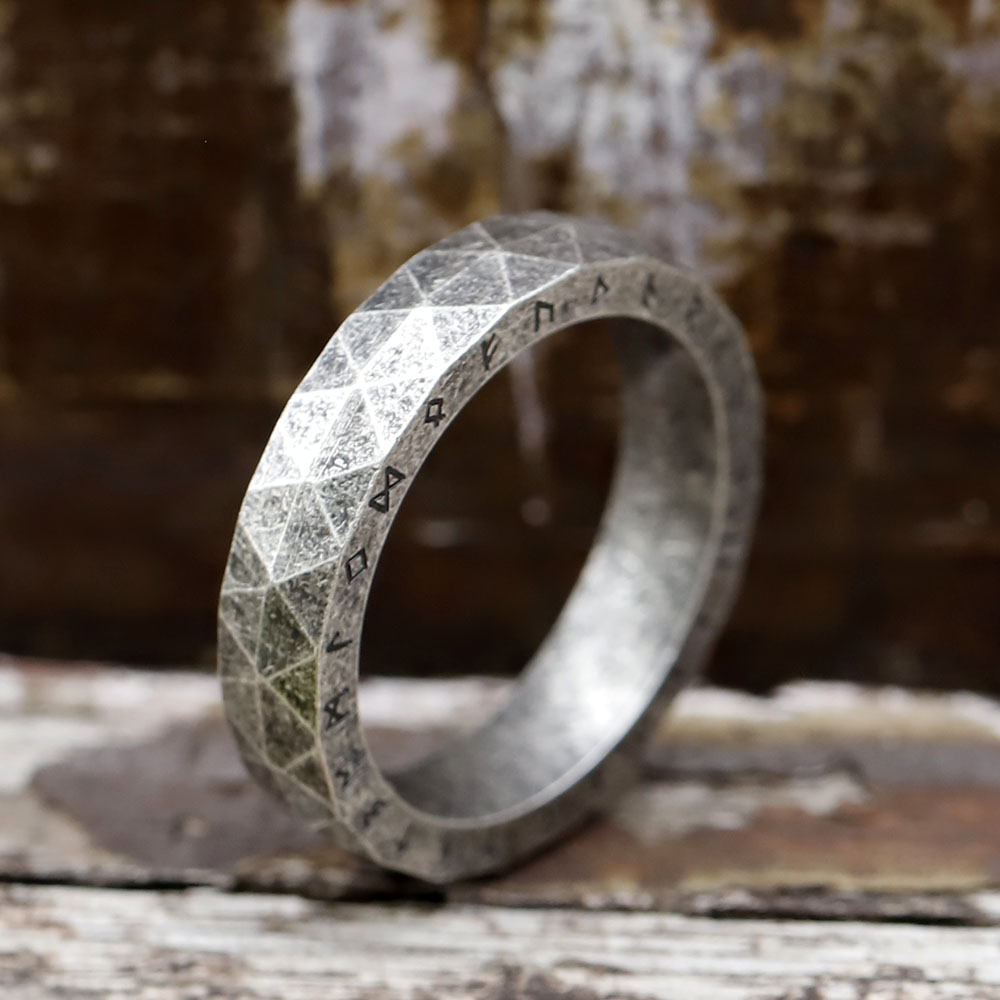 Detailed close-up showing the intricate polygonal facets and brushed finish of the Viking ring.