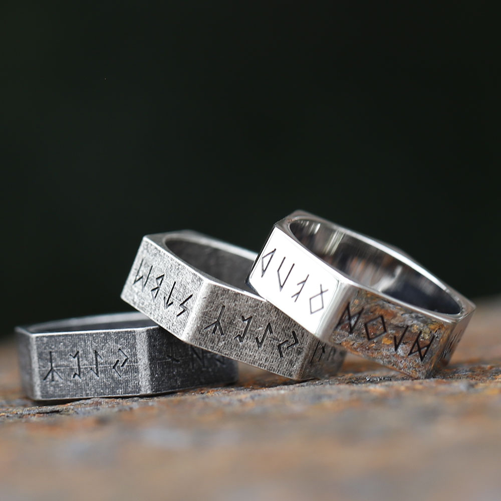 Angled view of the rugged stainless steel hexagon ring, highlighting its textured surface and etched runes.