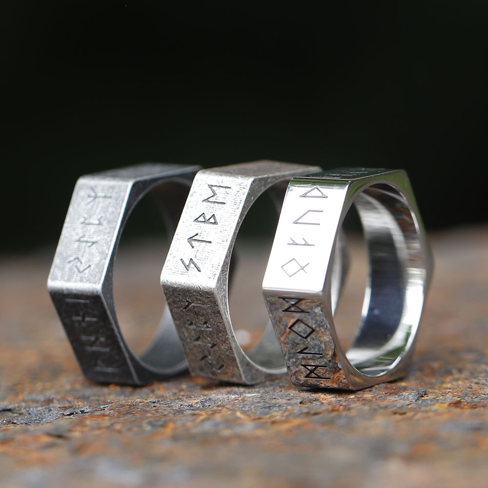 Close-up of the top facet of the hexagon ring, detailed with ancient Nordic rune engravings.