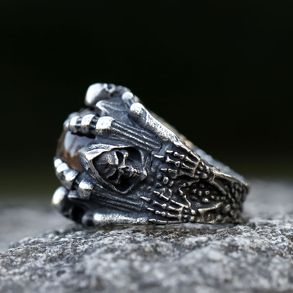 Detailed shot of the brushed stainless steel texture and gothic engravings on the men's punk ring.