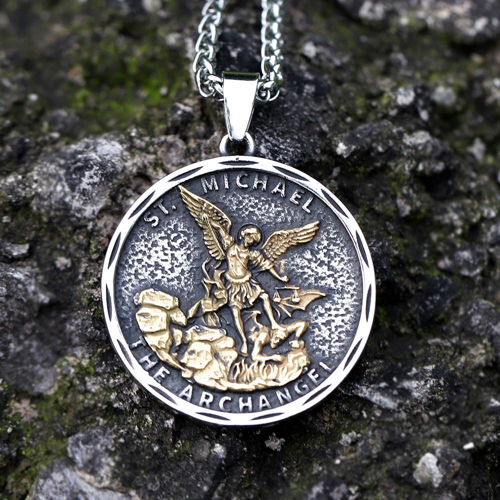 Men's stainless steel Archangel St. Michael guardian pendant necklace on a mossy rock.
