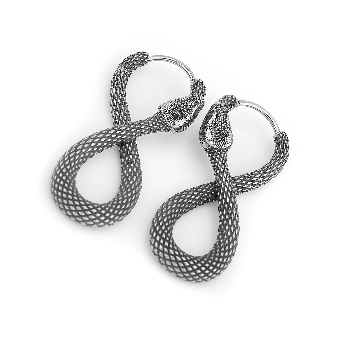 Close-up shot emphasizing the textured scales and intertwined design of both snake earrings in the box.