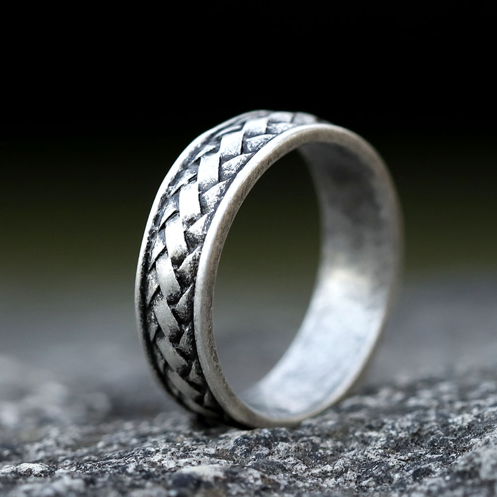 Angled close-up highlighting the braided texture and the slightly oxidized finish of the Viking ring