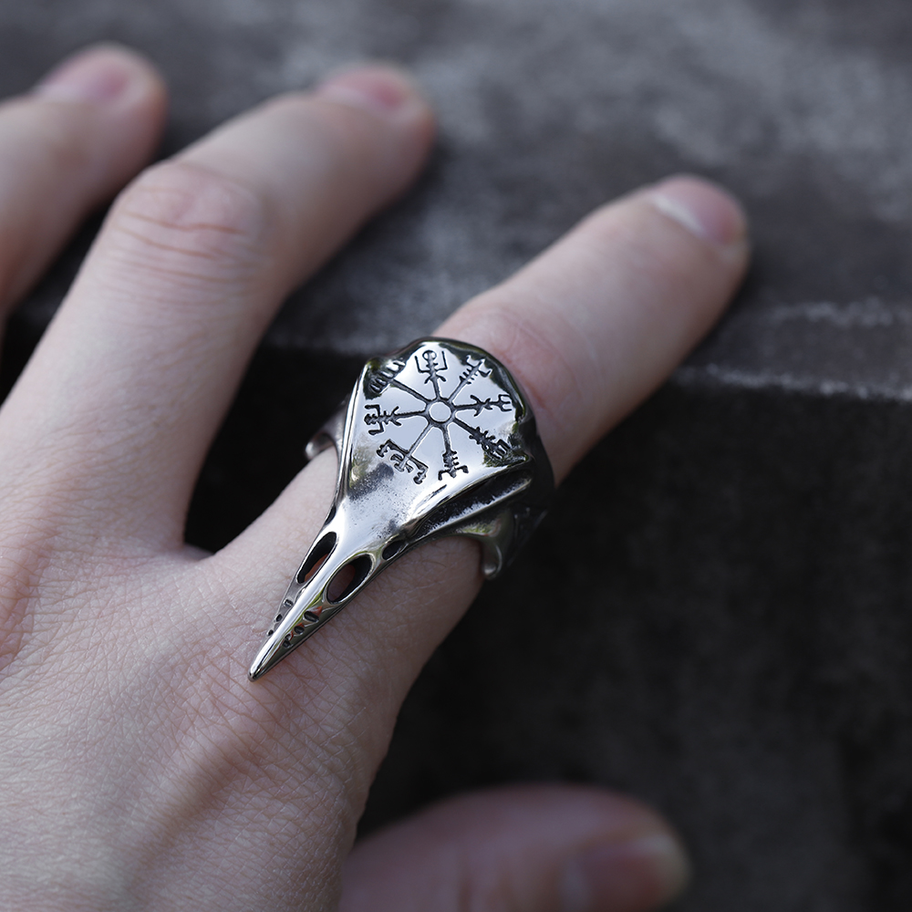 View of the raven's beak and the detailed patterns on the side of the Viking-inspired ring.