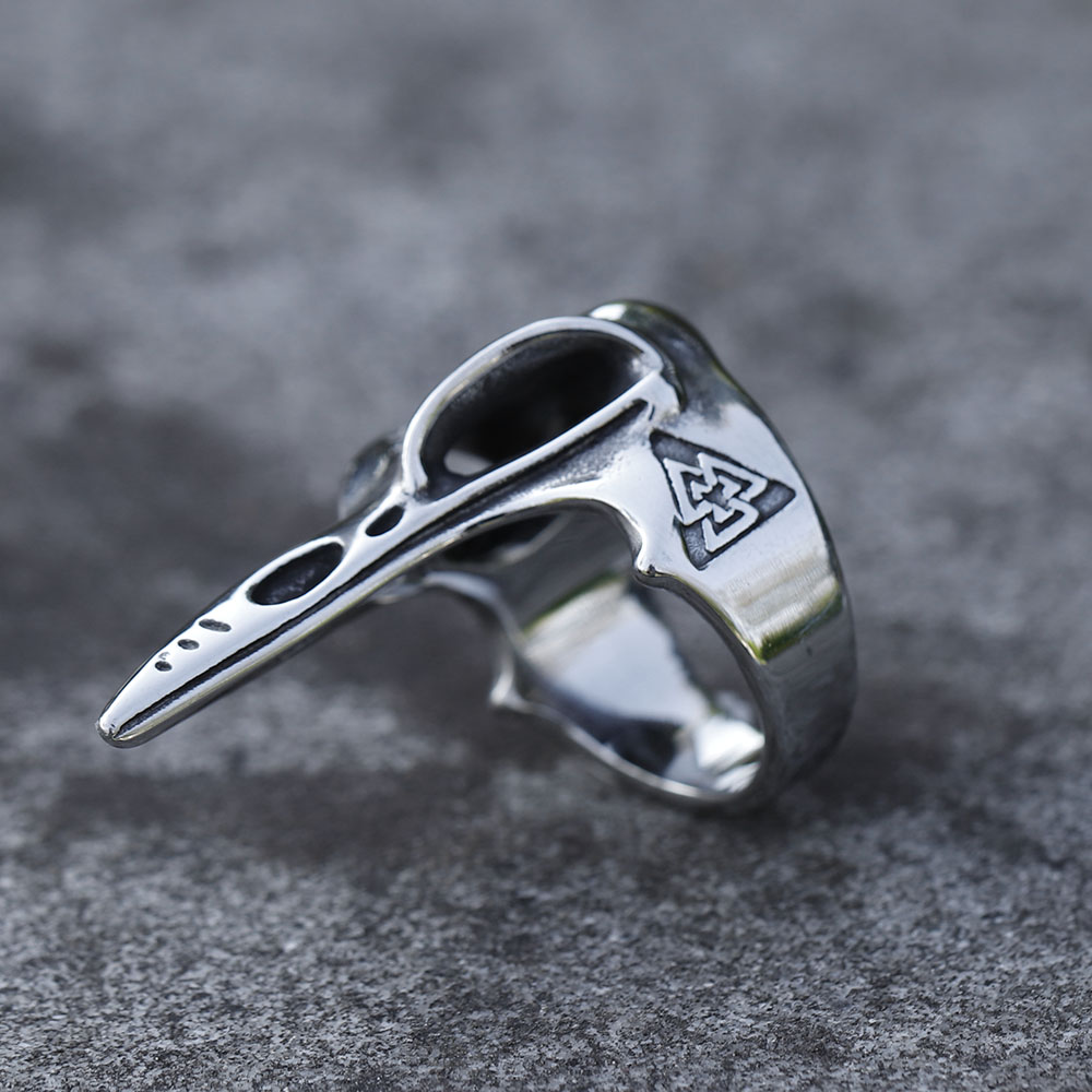 Intricate shot highlighting the elongated beak of the stainless steel raven head ring.